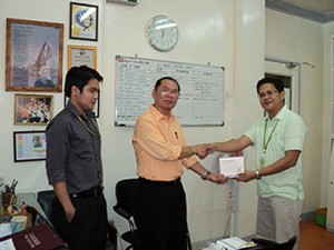 Mr. Michael Jibson Hernandez, Executive Assistant Designate of PhilHealth, hands over to DSWD's Assistant Regional Director Jaime Eclavea boxes of flu vaccines. Looking on is Mr. Emmanuel Relador, also of PhilHealth. The PhilHealth Regional Office donated 100 flu vaccines to the DSWD Field Office Eight. The donation took place in Director Eclavea's office on July 4, 2011. PhilHealth is a partner agency of the DSWD.