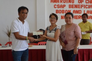 Mayor Quintin Saludaga receives the checks from PPDC Yvonne Abonales for the CSAP beneficiaries from Lavezares, N. Samar.