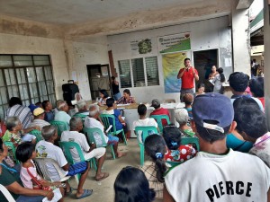 PDO Juel Ramos briefs ESA beneficiaries on distribution of cash assistance.