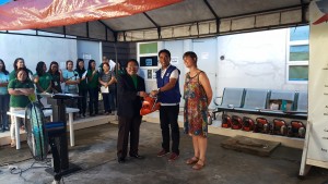 RD RBM accepts the chainsaws (handed to him and in background) from IOM representatives Francis Cleto Abad and Megan Genat.