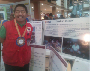 DSWD Region VIII Director Restituto Macuto, poses with their agency's exhibit on Disaster Response,  minutes before the launching program held recently at the Robinson's Place - Tacloban.